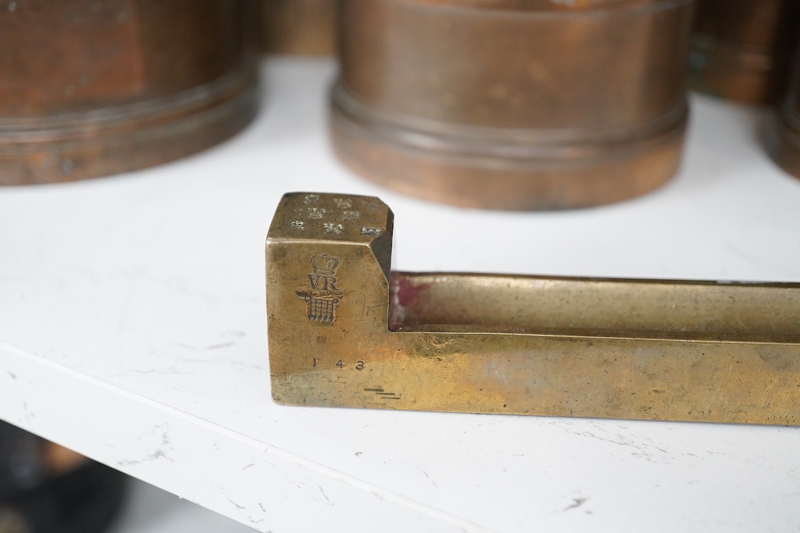A George IV Imperial brass yard stick, engraved with County of Surrey 1825, with official stamps and crowned VR, etc.